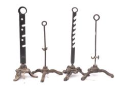 Four various iron spit holders: with ring handles on tripod bases.