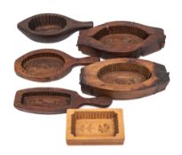 An oval treen hinged butter mould: decorated with a cow, 26cm long,