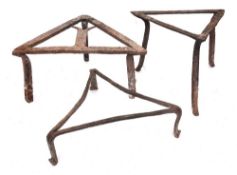 A triangular grid iron: on three splayed feet, 32cm, also two triangular-shaped iron brandreths,