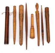 A collection of seven treen fruit spurtles:, also a thermometer in wood holder.