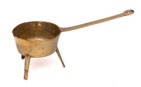 A 17th Century cast brass skillet: of circular form, on tripod splayed legs, diameter of bowl 11.