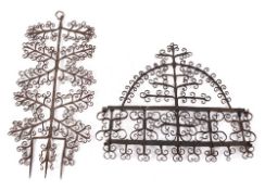 A decorative wrought iron wall mounted rack: of domed outline with five hooks,