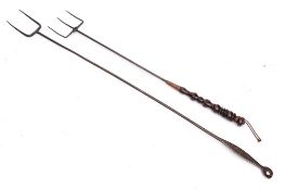 A three pronged metal toasting fork: with copper mounted turned wood handle,