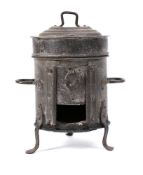 A small tin circular drum-shaped cooking stove and cover: with twin handles and tripod splayed legs,