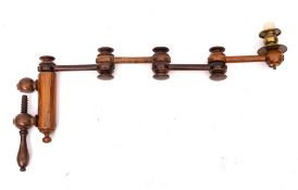 A 19th Century turned wood adjustable candle sconce: with screw clamp, having a brass sconce.
