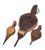 A set of carved wood and suede leather bellows:, decorated with a face,