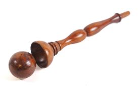 A lignum vitae cup and ball game: with turned inverted twin baluster stem, 24cm high.