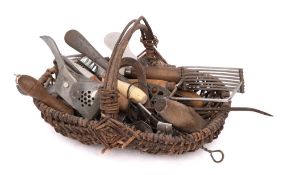 A collection of miscellaneous kitchen utensils: contained in a wicker basket.
