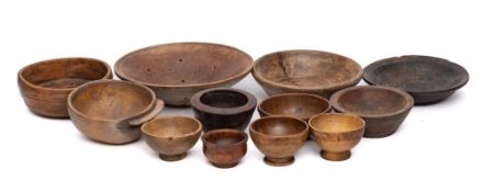 Two fruitwood circular sieves: and a collection of circular wood bowls.
