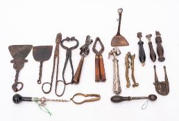 Three iron scrapers and peels:, two pairs of nutcrackers, a knife sharpener with wood handle,