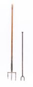 A metal three pronged cooking trident: with long turned wood handle, 156cm long,