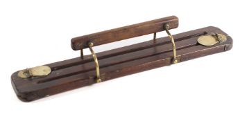 A late 19th/early 20th Century oak and brass mounted game carrier: with twin divisions, 49 x 9.5cm.