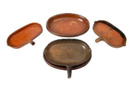 A terracotta and slip glazed oval fat catcher: with single handle and lipped bowl, 33cm long,