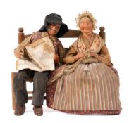 An attractive French painted group of a rustic man and woman on a ladderback chair:,