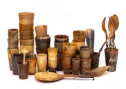 A collection of horn beakers, spoons and salad servers:.