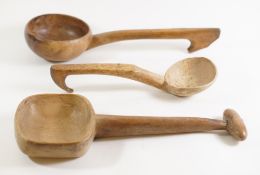 A collection of seven treen ladles: of various designs, a treen skimmer and four other items.