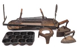 An iron rectangular fat catcher:, an iron spit holder,