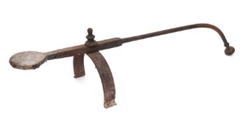 A wrought iron salamander: with turned finial on U-shaped support, 18th Century.