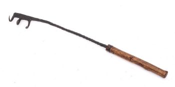 A rare early iron flesh fork: with triple hooks, spiral stem and wood handle, 54.5cm long.