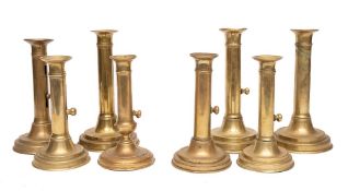 Eight various 19th Century brass ejector candlesticks: on circular bases.
