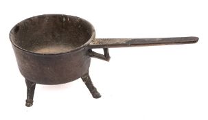 A 17th/18th Century brass skillet: of circular form, the handle with open bracket,