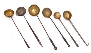 A collection of six brass ladles, pans: and a single sieve lipped ladle.