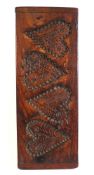 A rectangular biscuit mould: with four impressed hearts and foliate stem decoration, 54 x 20cm.