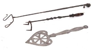A pierced steel heart-shaped skimmer: with shaped handle and ring terminal,