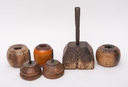 An antique rustic iron candle holder: on wood square block bevelled base, 25.
