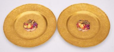 A pair of Royal Worcester porcelain cabinet plates: each decorated with a panel of apples ,