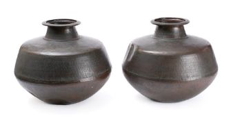 A pair of Rajasthan beaten copper water jars: of ovoid form with flared rims, on flattened bases,