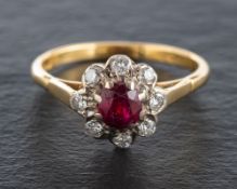 An 18ct gold, ruby and round, brilliant-cut diamond cluster ring,