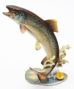 A German Hutschenreuther porcelain model of a Rainbow Trout: leaping above lily pads,