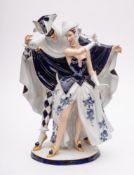 A Royal Dux Bohemia porcelain group: of an elegant couple dancing at a masquerade ball,