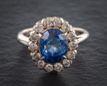 A 18ct white gold, synthetic sapphire and round brilliant-cut diamond cluster ring,