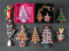 Seven Christmas brooches, two other brooches and Christmas tree keyring by Butler and Wilson,