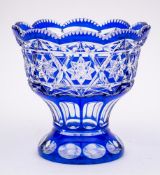 A blue flashed glass vase: of pedestal form printies, slice cut and stellar decoration,