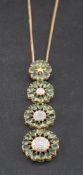 A prasolite and diamond pendant of graduated stylised flowerhead design,: length ca. 7.