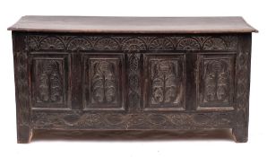 A Jacobean oak coffer, circa 1680,: the hinged cover above an arcaded frieze carved in low relief,