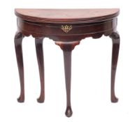 A George II mahogany demi-lune tea table, circa 1740,: with two hinged tops,
