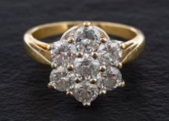 An 18ct gold, round, brilliant-cut diamond cluster ring,: total estimated diamond weight ca. 1.