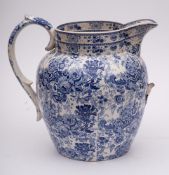 A large Staffordshire blue and white pottery jug: with scroll handle,