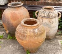 Three terracotta garden pots, 20th century,: the largest example,