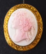 An 18ct gold, Victorian, shell cameo brooch:, depicting Dionysus in profile with grapes in hair,