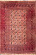 A Belouchistan carpet:, the brick red field with four rows of quartered medallions,