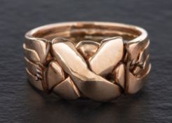 A puzzle ring comprising four interlocking rings,: length of ring head ca. 1.