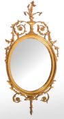 A Victorian carved and giltwood framed oval wall mirror, in Neoclassical style, circa 1875,