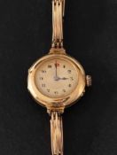 An 18ct gold wristwatch, the gold-coloured dial with Arabic numerals and spade hands,
