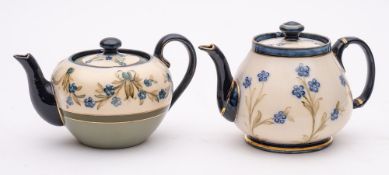 Two James MacIntyre Dura Ware tea pots: each tube lined respectively with a row of blue and pale
