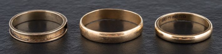 Two 9ct gold rings and a third ring,: the third ring with engraved monogram 'AM',